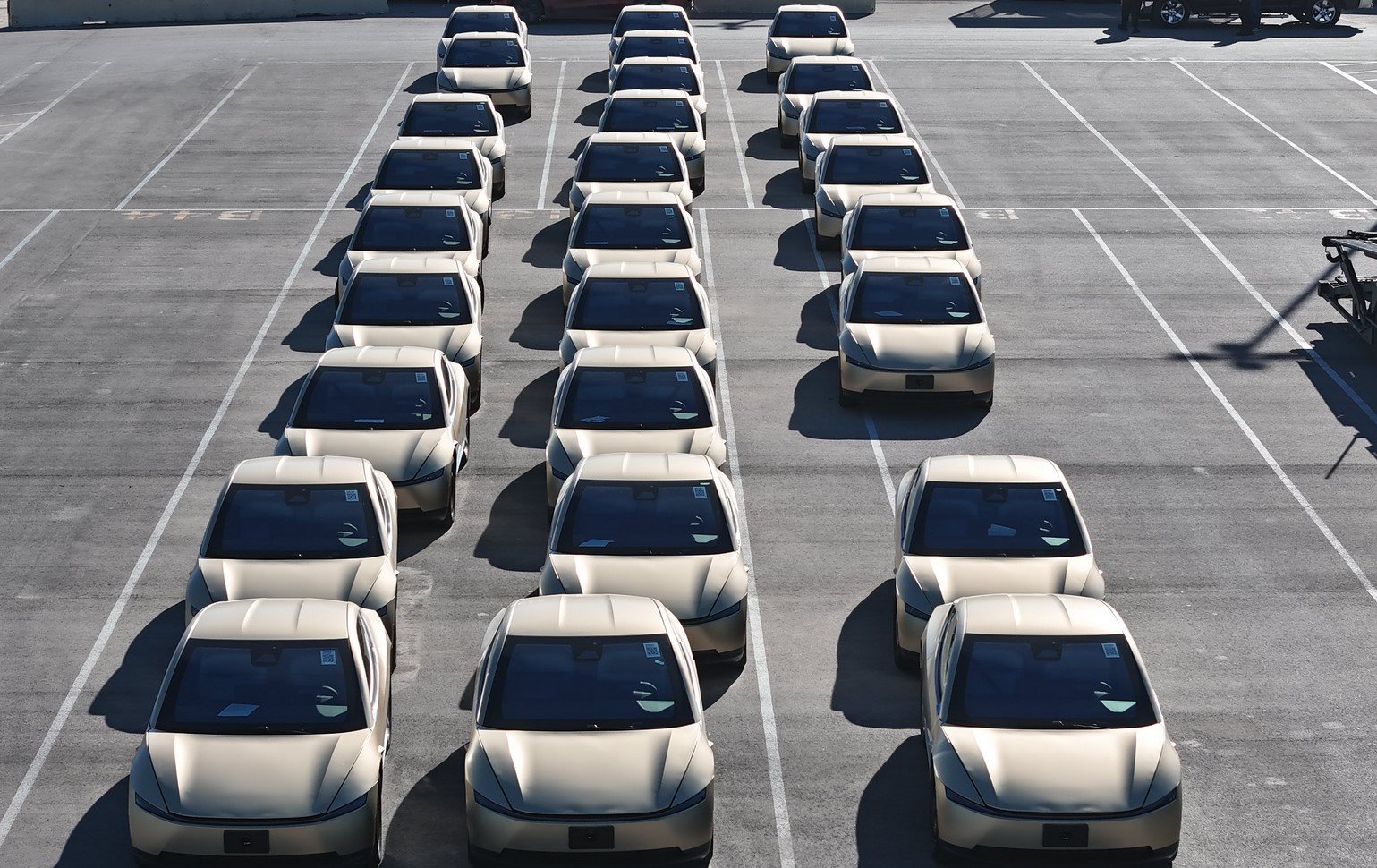 Aerial drone footage of Tesla Cybercab fleet parked at Giga Texas outbound lot May 2026