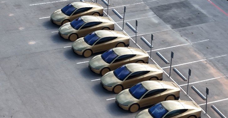 Cybercabs with the Reaction Injection Molding gold panels lined up outside of Giga Texas preparing for additional Robotaxi service testing on 7 July 2026